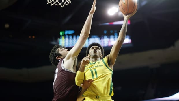 Nov 29, 2021; Eugene, Oregon, USA; Oregon Ducks guard Rivaldo Soares (11) shoots the ball as Montana Grizzlies forward Josh Bannan (13, left) defends during the first half at Matthew Knight Arena. Mandatory Credit: Soobum Im-USA TODAY Sports